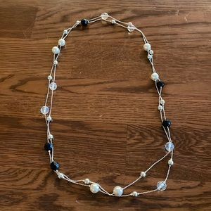 Long necklace with white, clear, and black beads